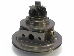 Hyundai turbo core 16399700016 / 28231-2B760, side view showing the oil ports and compressor wheel — Hatach Turbo, Ultimate Autoparts SA